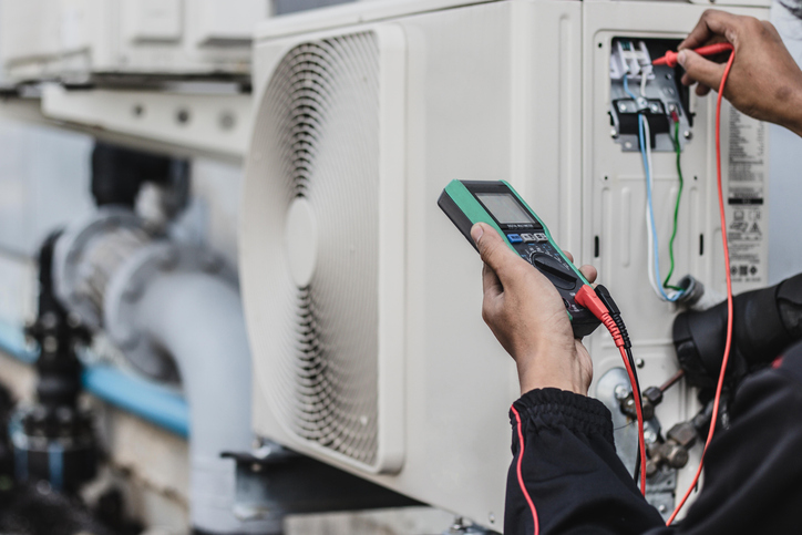 image of a air conditioning unit being serviced by a technician